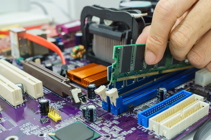 Technician’s hands Installing RAM